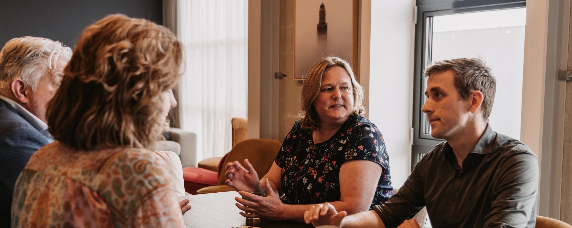 Ryanne bespreekt contentonderzoek met drie klanten aan een vergadertafel